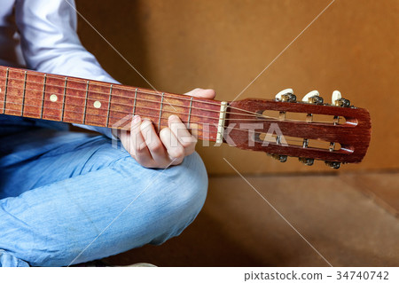 young woman playing guitar young woman playing guitar 34740742