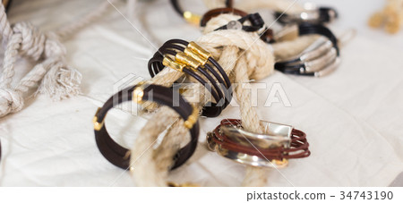 Colored bracelets lying on the counter 34743190