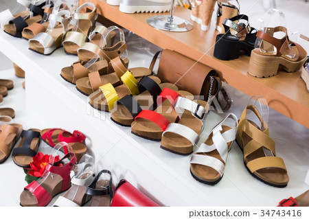 Image of showcase with summer shoes in the store. 34743416