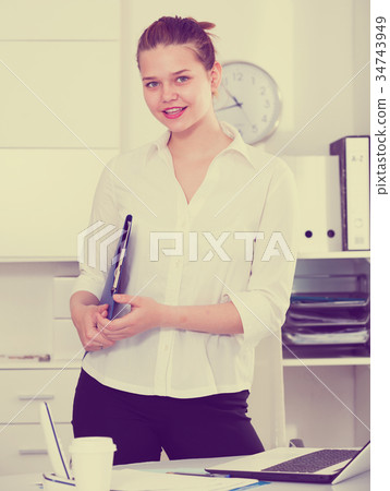 Businesswoman is standing with documents 34743949