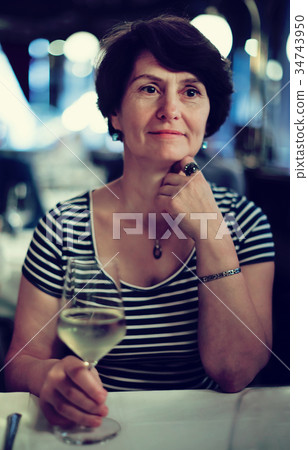 Elderly lonely woman at dinner in restaurant Elderly lonely woman at dinner in restaurant 34743950