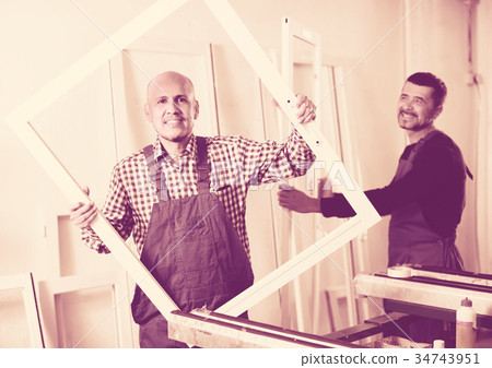 Workers with PVC windows and doors . 34743951