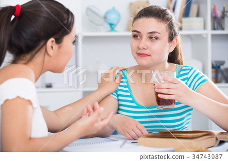 Girls enjoying conversation and cup of coffee 34743987
