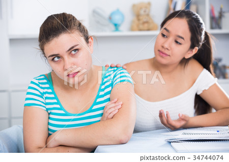 Girl trying to apologize to friend Girl trying to apologize to friend 34744074