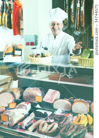Salesman offering different sausages Salesman offering different sausages 34744075