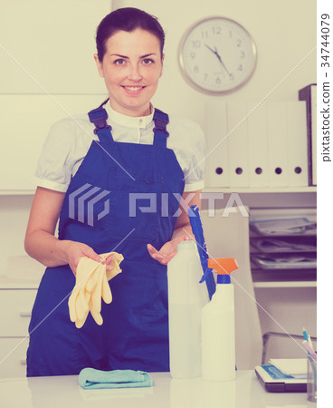 Young and smiling woman cleaning room Young and smiling woman cleaning room 34744079