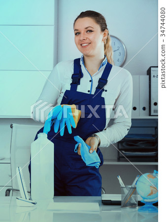 Smiling girl cleaning the room 34744080