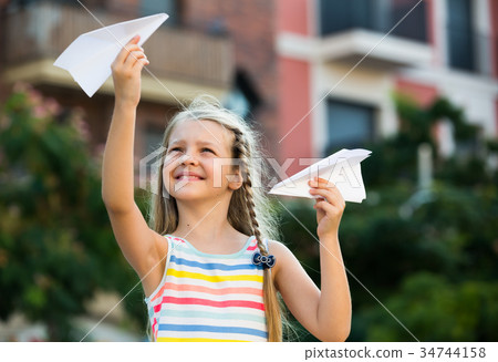 happy girl playing paper plane 34744158