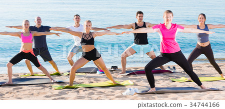 People doing exercises on beach People doing exercises on beach 34744166