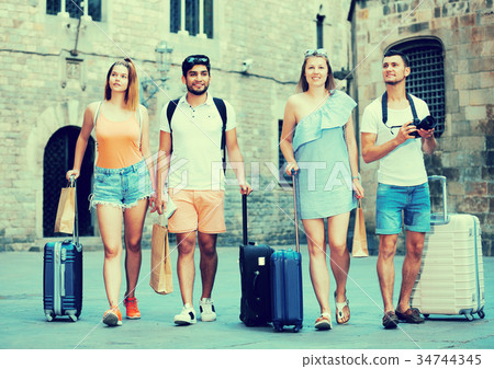 People taking promenade with suitcases People taking promenade with suitcases 34744345