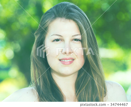 Portrait of smiling female which is sitting on bench Portrait of smiling female which is sitting on bench 34744467