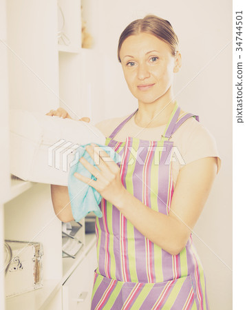 Woman wiping jewelry box 34744501