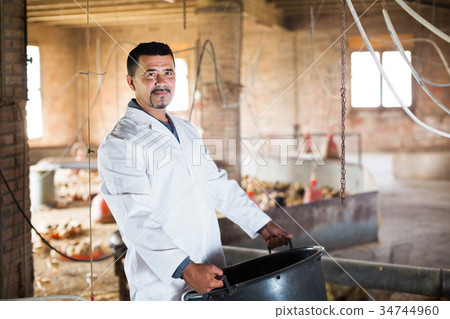 Worker holding plastic bucket Worker holding plastic bucket 34744960
