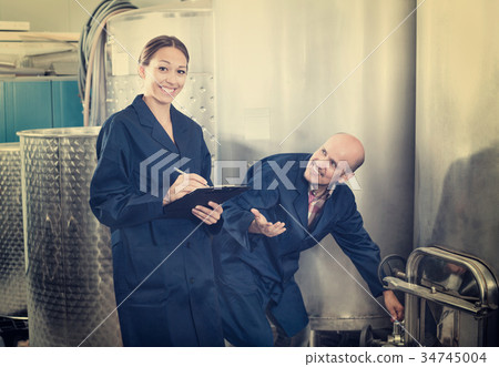 Woman and standing man in fermentation section Woman and standing man in fermentation section 34745004