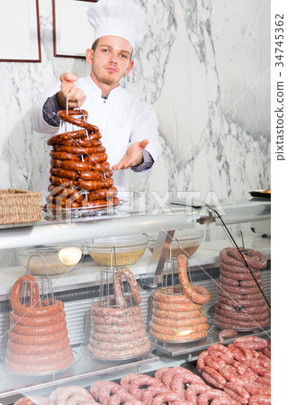 friendly young seller offering fresh products friendly young seller offering fresh products 34745362