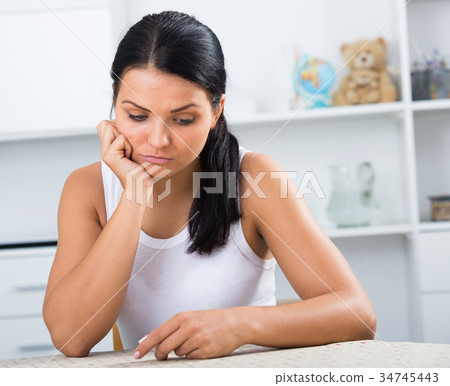 Young brunette woman wipes tears 34745443
