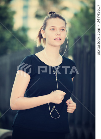 Girl jogging outdoor with music 34745617