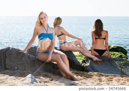 Girl in bikini taking sunbath Girl in bikini taking sunbath 34745666