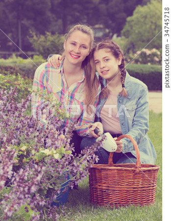happy young woman and teen with gardening tools in outdoors 34745718