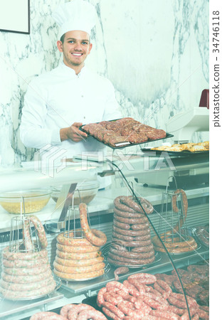 Young professional cook laying out food Young professional cook laying out food 34746118