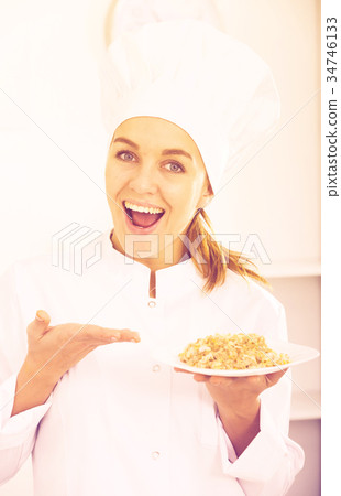 portrait of young coosie woman showing mush at kitchen portrait of young coosie woman showing mush at kitchen 34746133