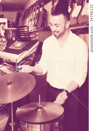 Male buyer selecting drums and accessories Male buyer selecting drums and accessories 34746155