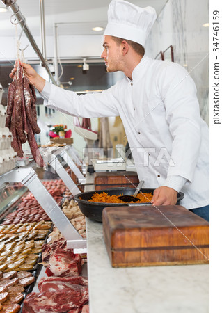 chief cooking fresh meat 34746159