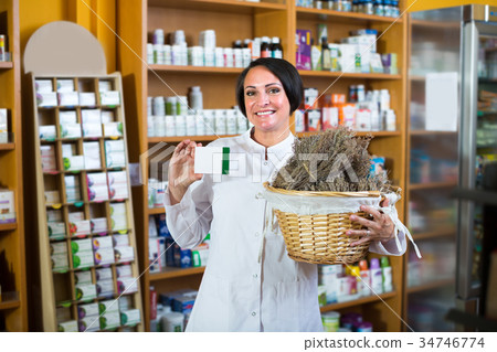 seller holding dried herbs seller holding dried herbs 34746774