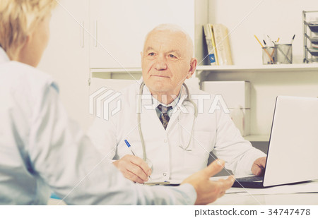 Male doctor with female client 34747478