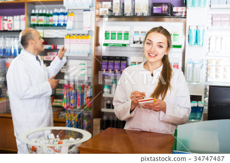 Two pharmacists at farmacy reception Two pharmacists at farmacy reception 34747487