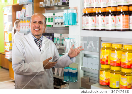 Male working in chemist shop 34747488