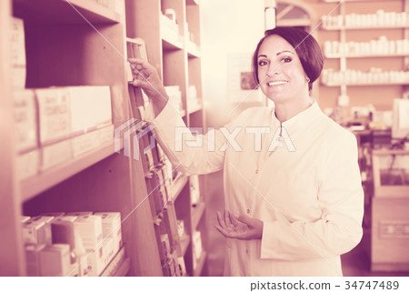 Smiling mature woman seller in drugstore 34747489