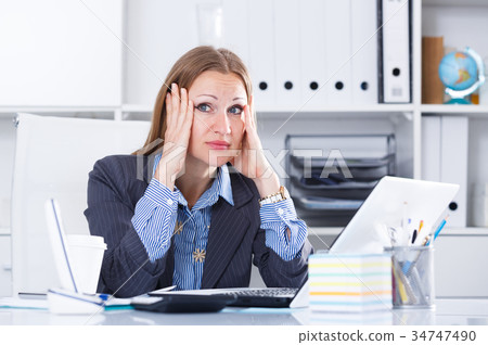 Upset businesswoman in office Upset businesswoman in office 34747490