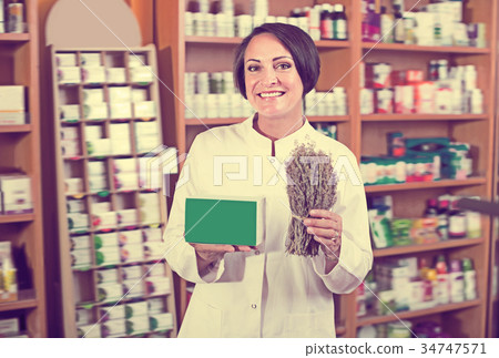 Portrait of happy female with dried plans Portrait of happy female with dried plans 34747571