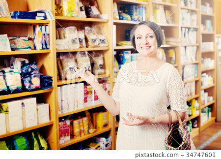 Woman shopping health supplements in drugstore 34747601