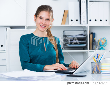 Young business woman at workplace 34747636