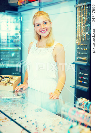 young female seller in bijouterie store . 34747696