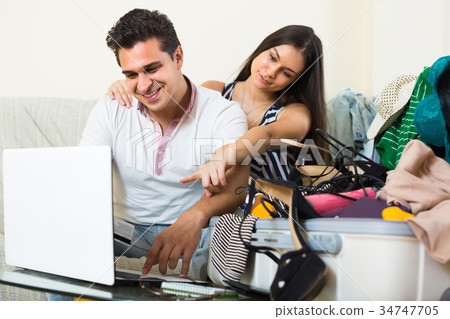Happy couple buying tickets online. Happy couple buying tickets online. 34747705
