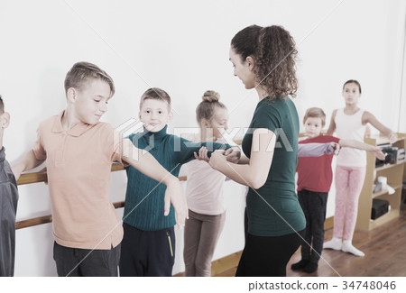Boys and girls rehearsing ballet dance in studio Boys and girls rehearsing ballet dance in studio 34748046