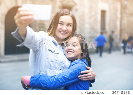 Mother and daughter photographing during tour 34748188
