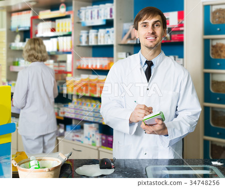 Portrait of male pharmacists working in modern farmacy 34748256