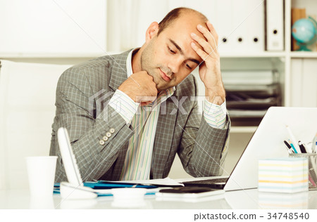 Male having lot of work and problems 34748540