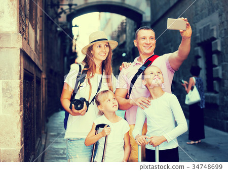 Travelers family taking selfie 34748699