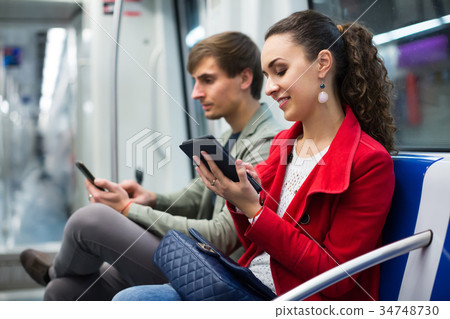 Ordinary people reading smartphone and e-book 34748730