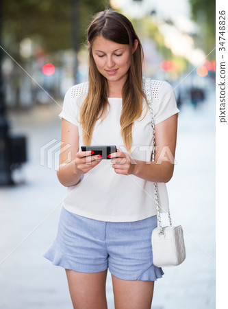 Romantic woman walking with phone 34748826