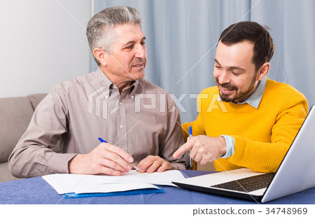 Man and sales manager discuss contract Man and sales manager discuss contract 34748969