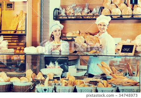Portrait of charming positive smiling couple at bakery display 34748973