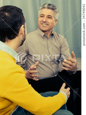 Adult father and son friendly conversation Adult father and son friendly conversation 34749042