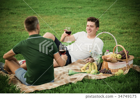 man with friend enjoying picnic 34749175