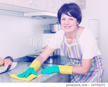 retiree woman cleaning home 34749201